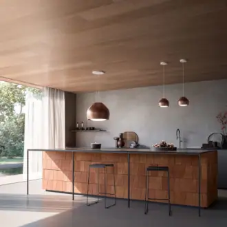 Falmec hood Sophie 54 worn copper over a kitchen island with two complementary pendant hoods, wood ceiling, and natural light