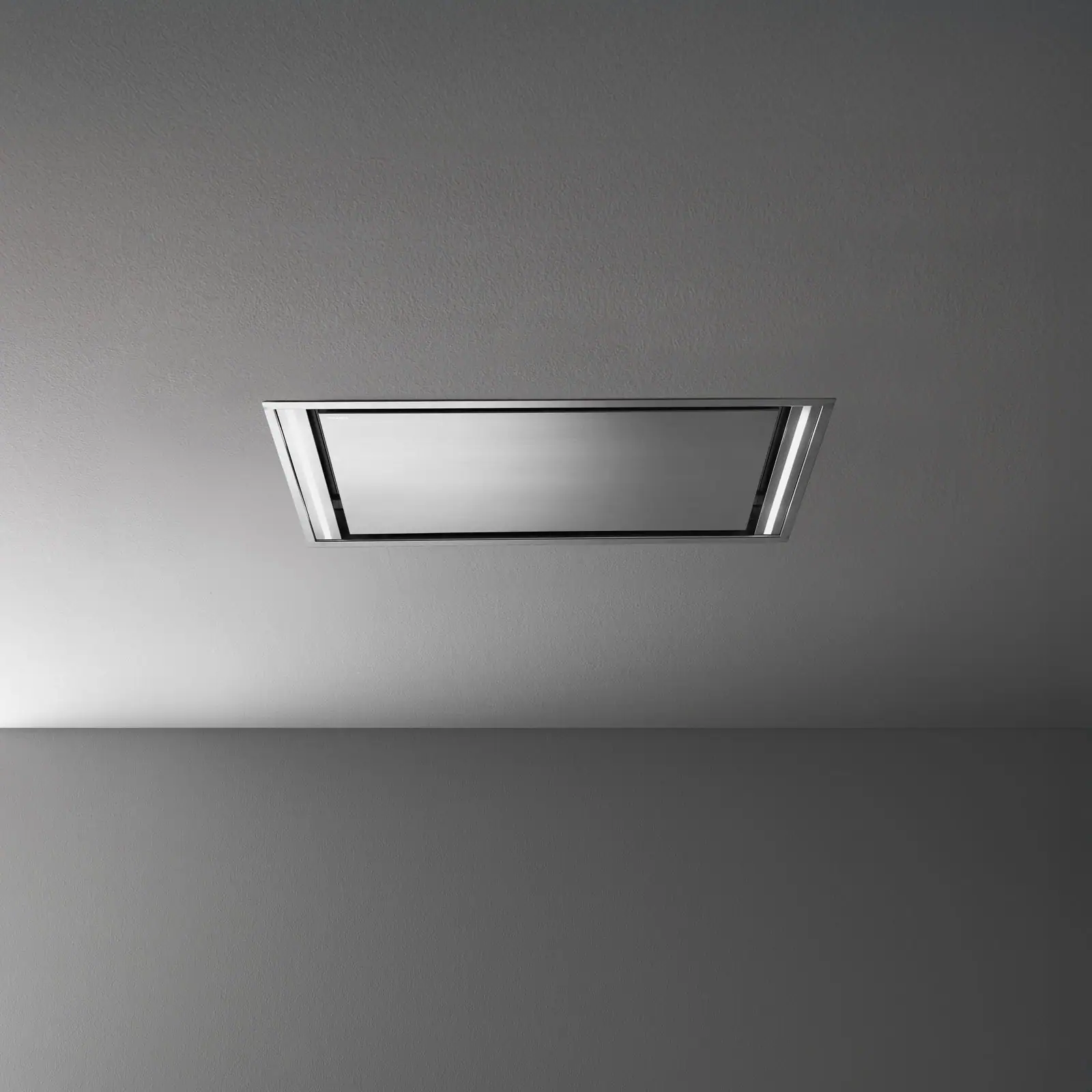 Falmec hood Stella Plus 120 Inox studio shot showing the recessed stainless panel and dual LED strip lighting on a grey ceiling