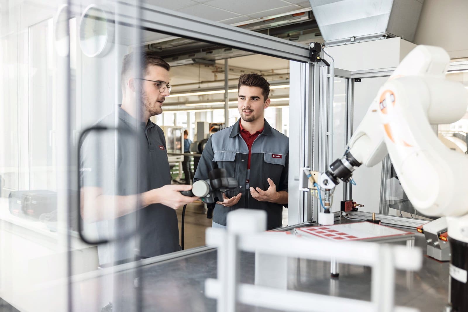 Miele engineers in conversation at the factory