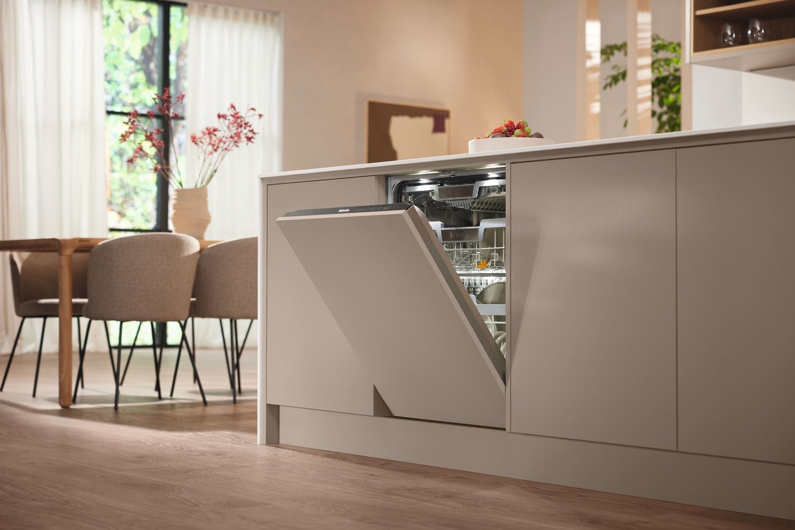 Miele fully integrated dishwasher built into cabinetry with its door open