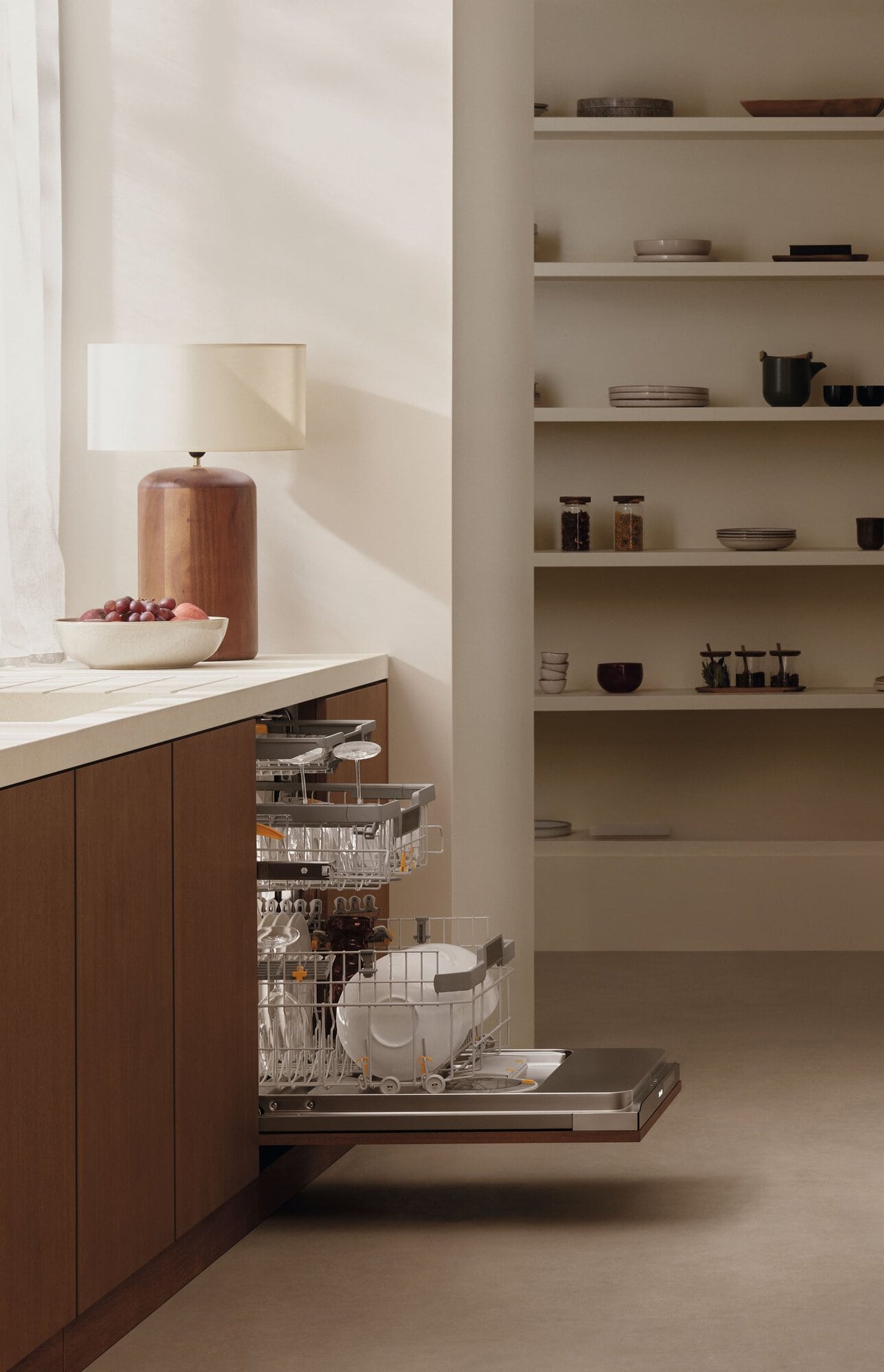 Side view of a loaded, open Miele dishwasher