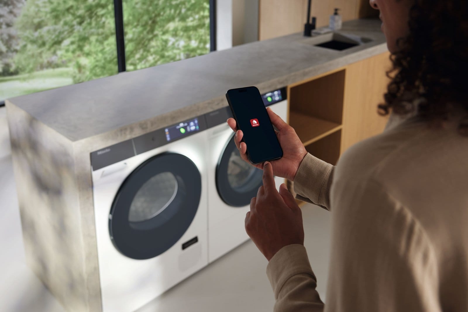 Checking the Miele app on a phone