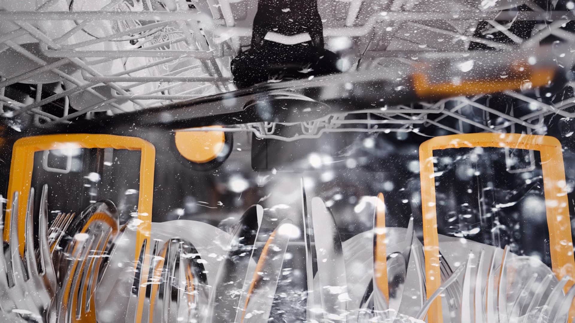 Spray arm in motion inside a Miele Professional dishwasher